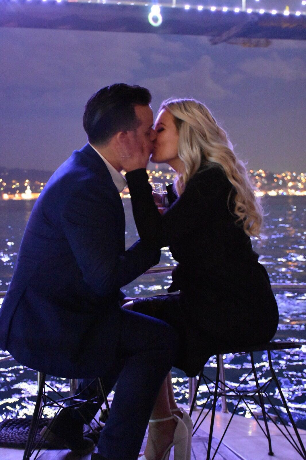 Couple celebrating their romantic marriage proposal on a luxury yacht on the Bosphorus.